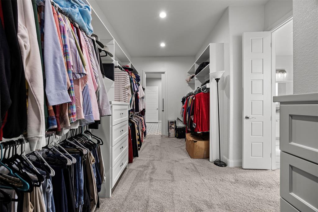 6381 Rigel Road Godley, TX 76044 - Photo 31 of 40 a view of walk in closet with clothes