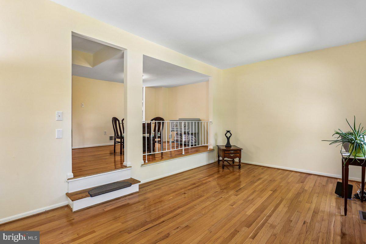 76 Timber Rock Road Gaithersburg, MD 20878 - Photo 12 of 51 a hallway with a large window and wooden floor