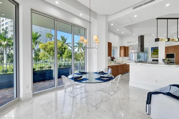 a kitchen with a large window appliances and living room view