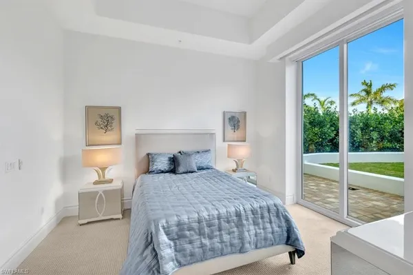 a bedroom with a large bed and a large window