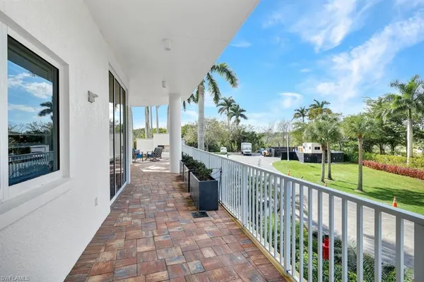 a view of a porch with wooden floor and fence