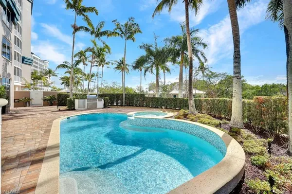 a swimming pool with outdoor seating and yard