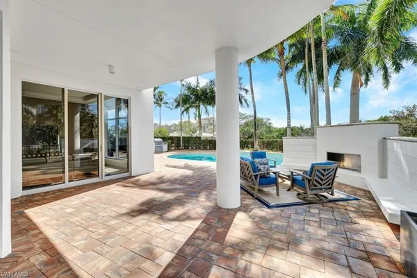 a building outdoor space with patio furniture and potted plants