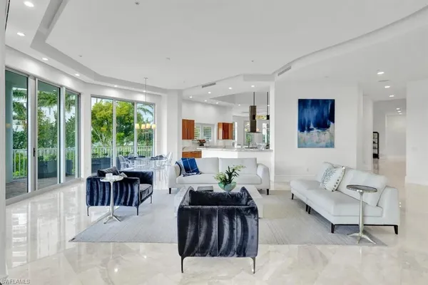 a living room with furniture and large windows