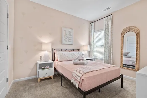 a bedroom with a bed and a large window