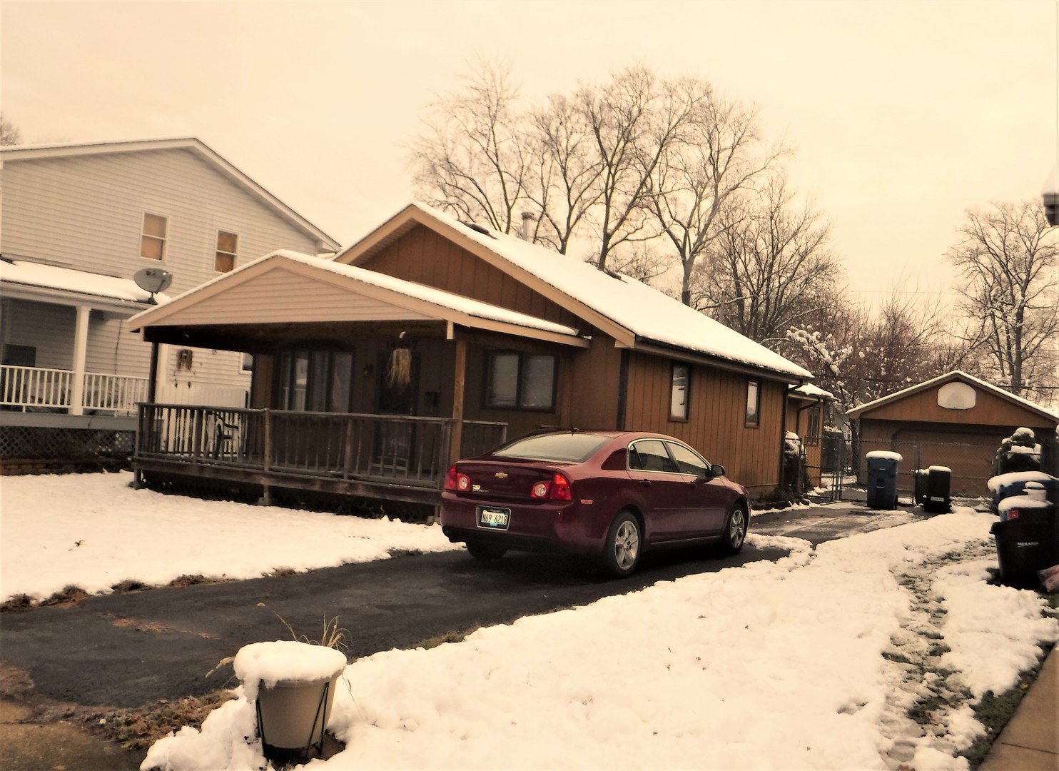 14447 Ridgeway Avenue Midlothian, IL 60445 - Photo 2 of 21 a front view of a house with a yard covered in snow