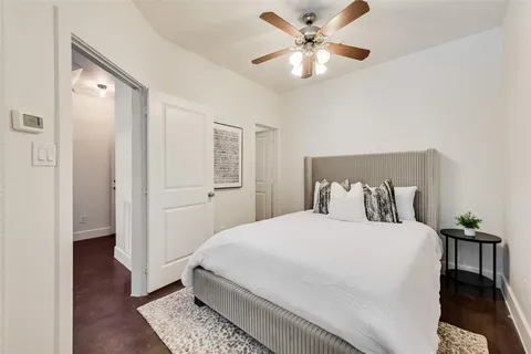 a bedroom with a large bed and a chandelier