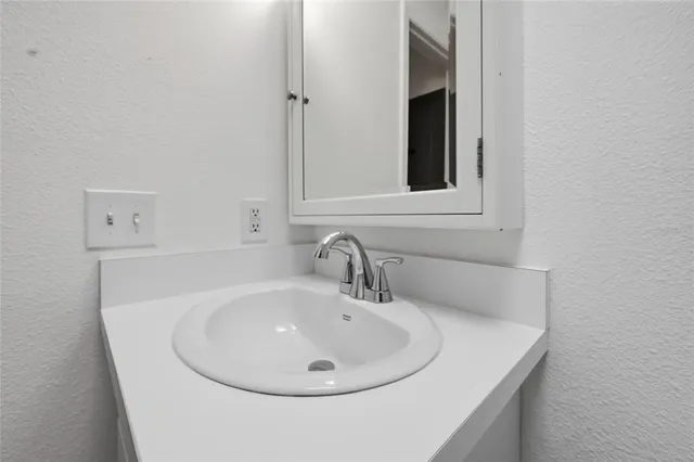 a bathroom with a sink and mirror