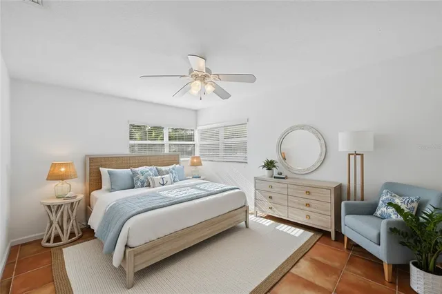 a bedroom with a bed a chandelier and a window