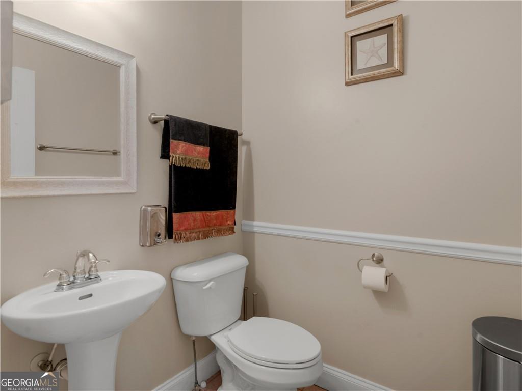 355 Parker Road Covington, GA 30014 - Photo 14 of 60 a bathroom with a toilet sink and mirror