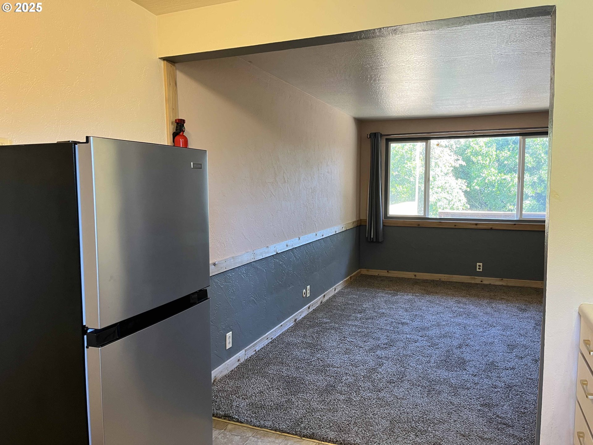 1260 10th Street, Unit 23 Florence, OR 97439 - Photo 16 of 19 an empty room with wooden floor and windows
