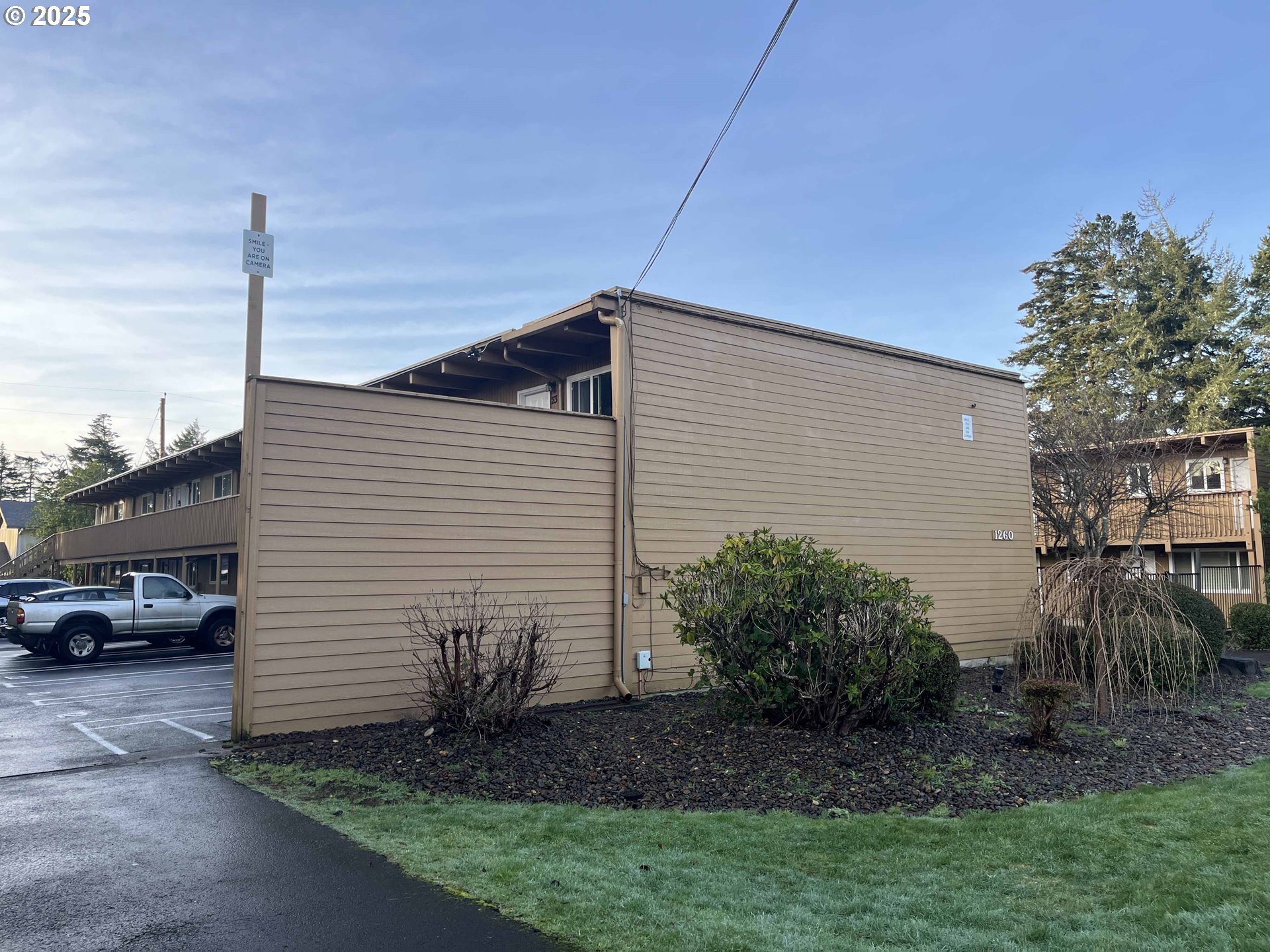1260 10th Street, Unit 23 Florence, OR 97439 - Photo 2 of 19 a view of a house with a patio