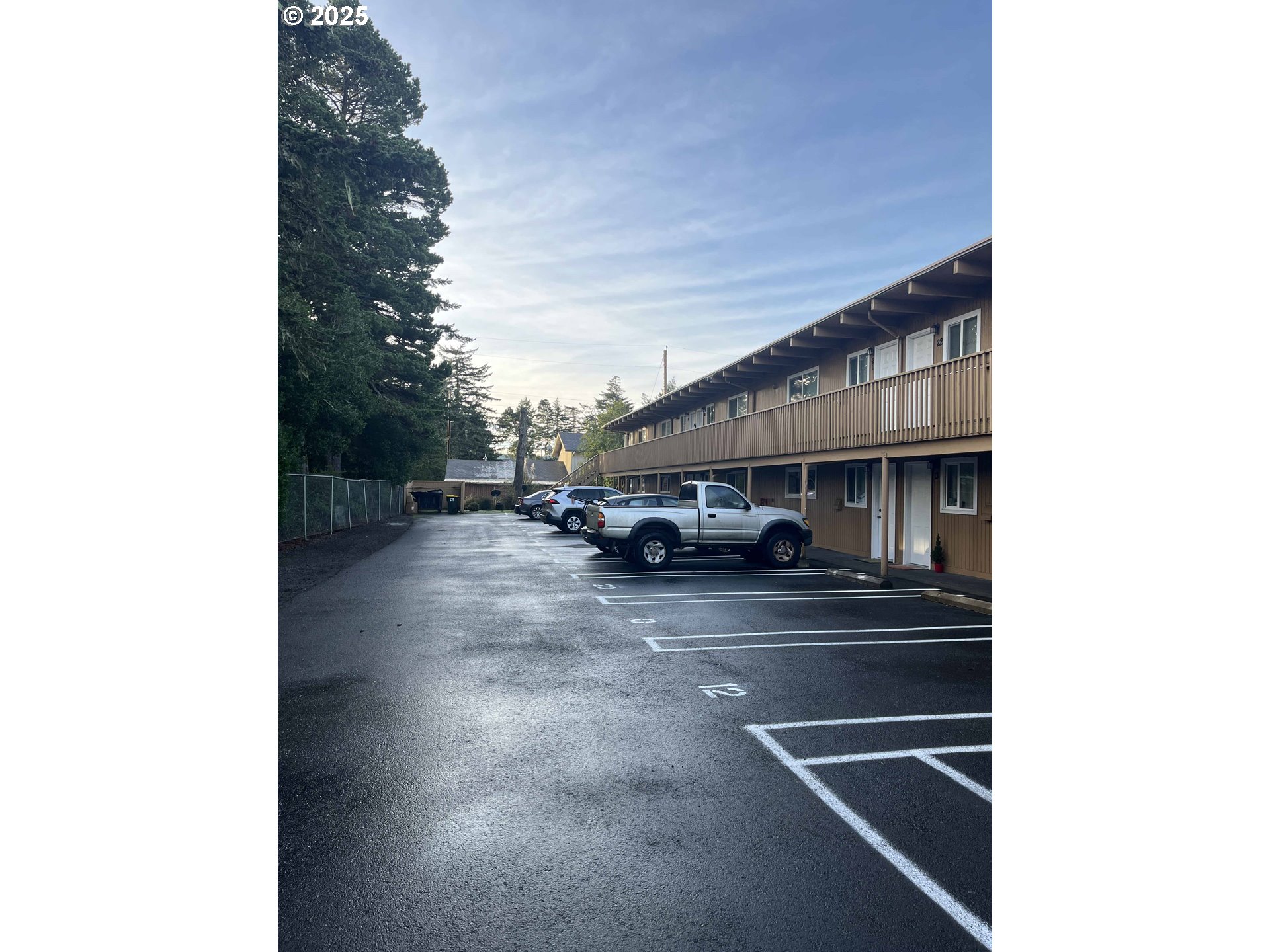 1260 10th Street, Unit 23 Florence, OR 97439 - Photo 3 of 19 a front view of a house with parking space