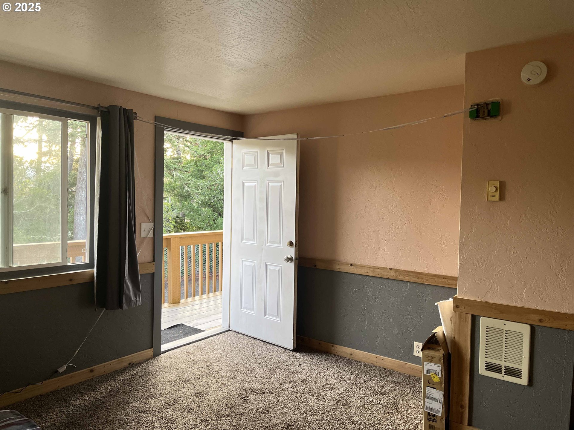 1260 10th Street, Unit 23 Florence, OR 97439 - Photo 5 of 19 a view of an empty room with a window