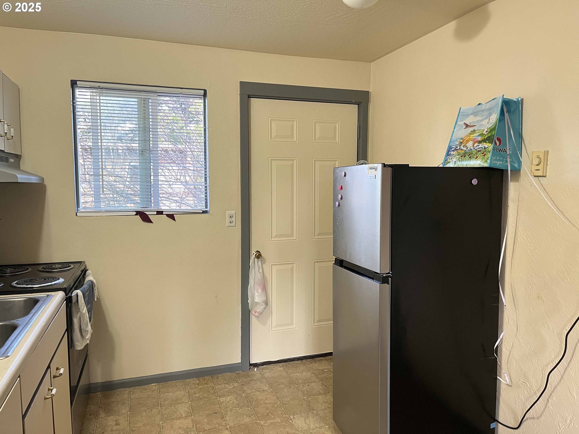 1260 10th Street, Unit 23 Florence, OR 97439 - Photo 7 of 19 a white refrigerator freezer and a stove top oven