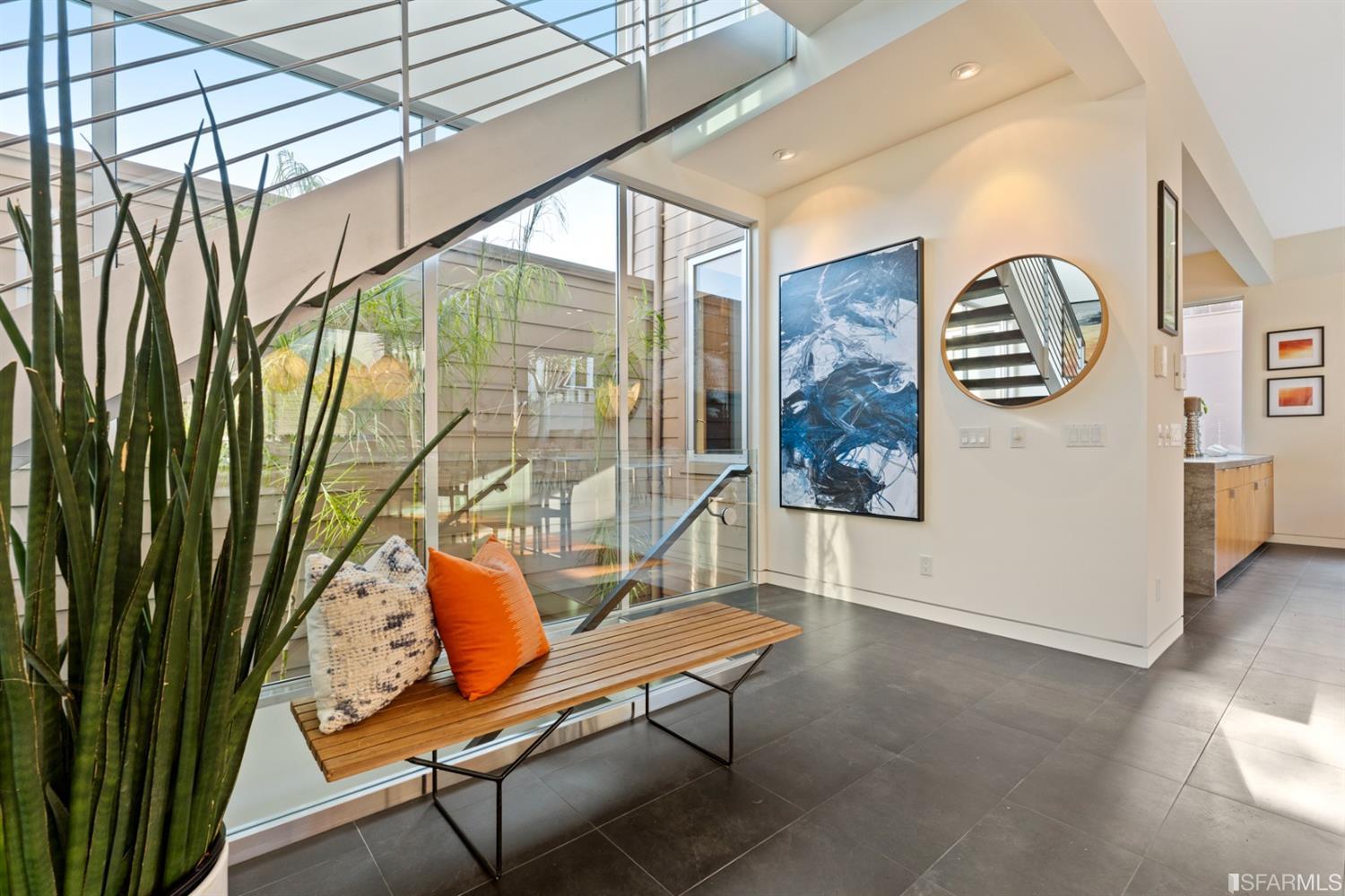 172 Prentiss Street San Francisco, CA 94110 - Photo 4 of 73 Living level staircase with wall of south-facing windows