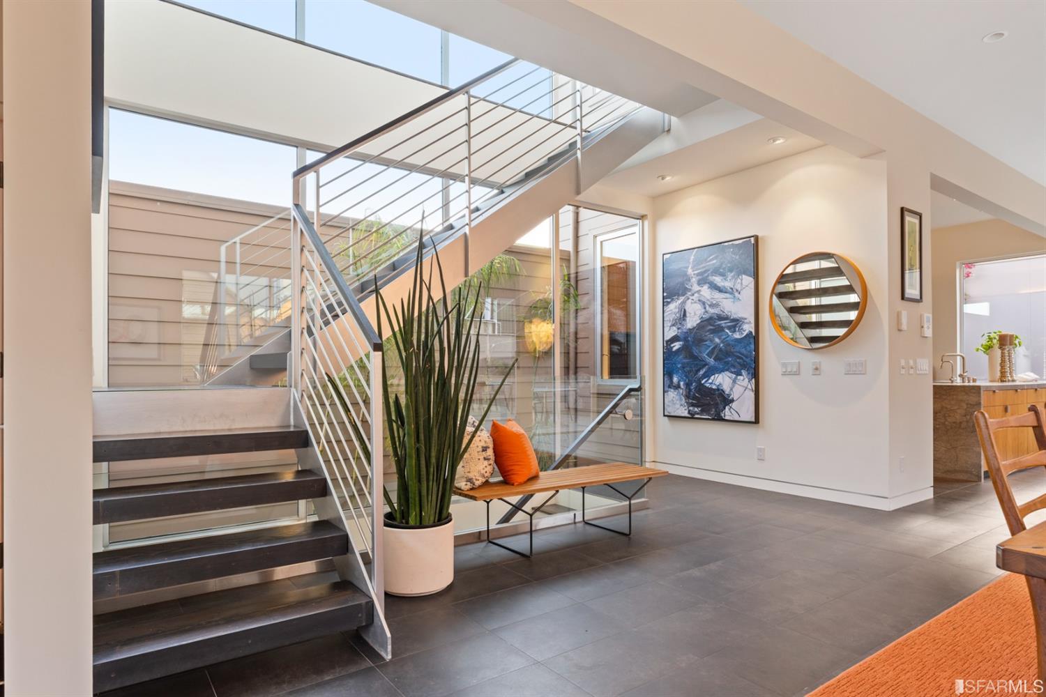 172 Prentiss Street San Francisco, CA 94110 - Photo 31 of 73 Staircase leads to sleeping level flanked by wall of windows over atrium
