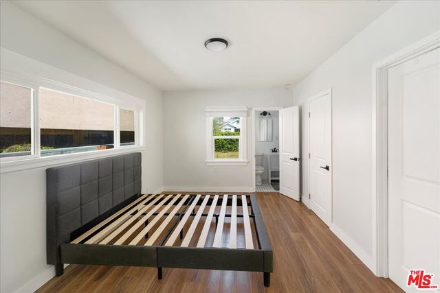 a view of a living room with furniture and wooden floor