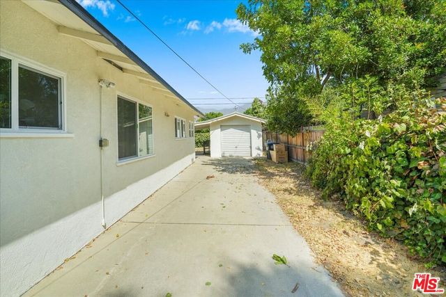 a view of house with backyard