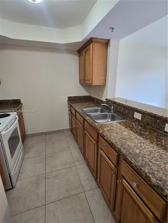 a bathroom with a granite countertop sink a washer and dryer