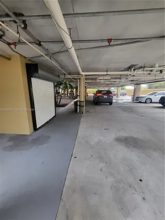 a view of parking garage with cars