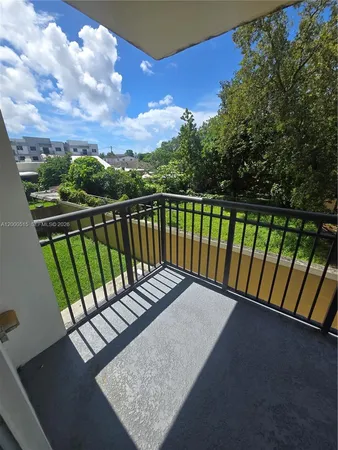 a view of balcony with wooden floor and fence