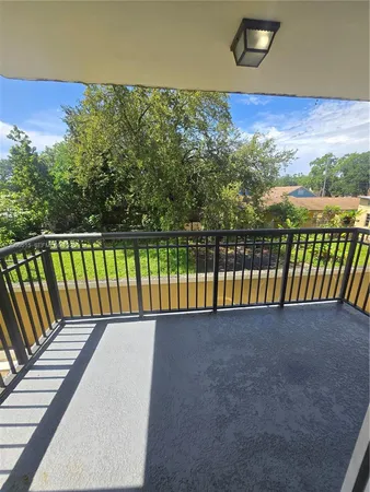 a view of a balcony with a forest