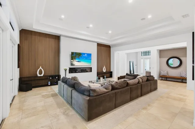 a view of a dining room with furniture large windows and a chandelier