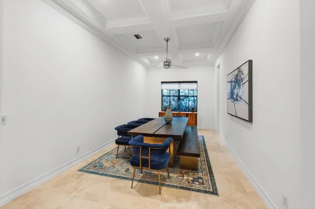a view of a hallway with wooden floor and a bathroom