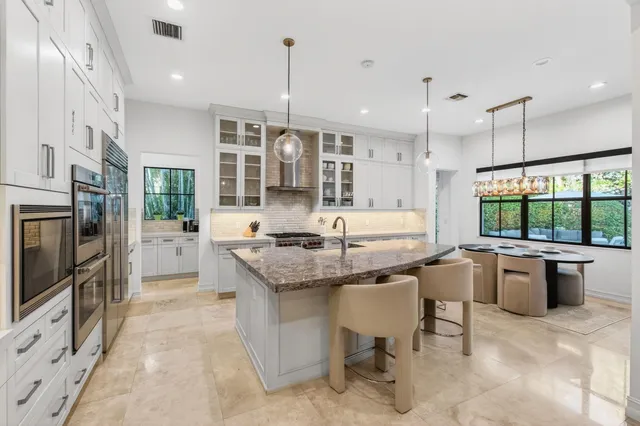 a bathroom with a sink double vanity granite and a mirror