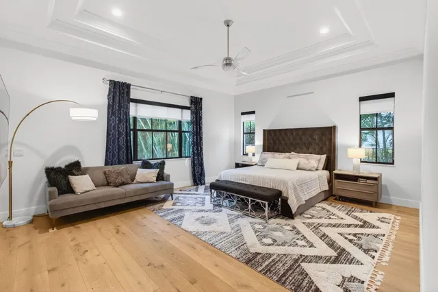 a view of swimming pool with lounge chair and trees