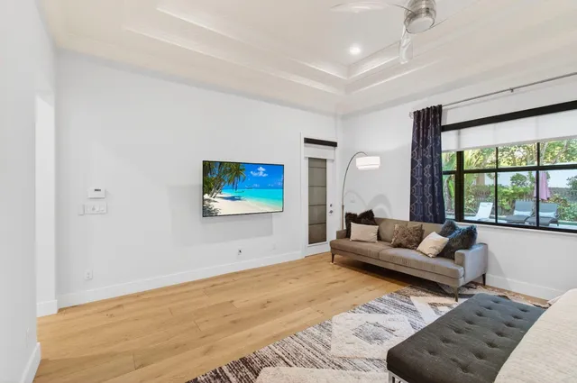 a view of a patio with table and chairs under an umbrella with large trees