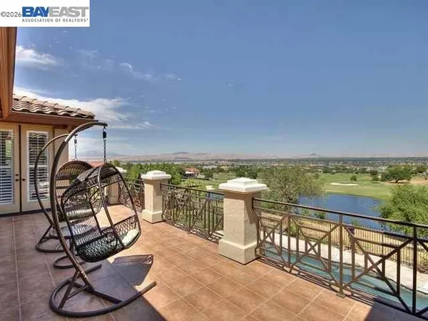 a view of a balcony with chair and table