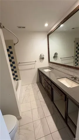 a bathroom with a sink a toilet and mirror