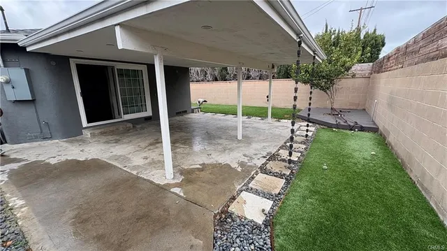 a backyard of a house with table and chairs