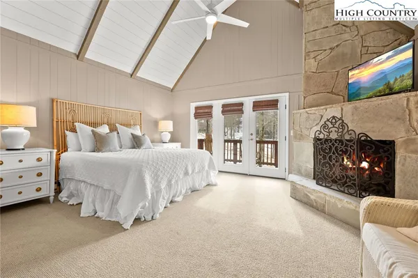 a spacious bedroom with a bed and a fireplace