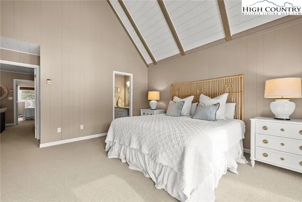 a bedroom with a bed and a night stand