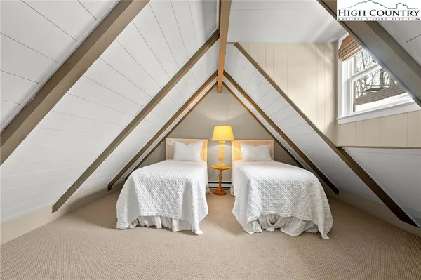 a view of bedroom with a bed and a window