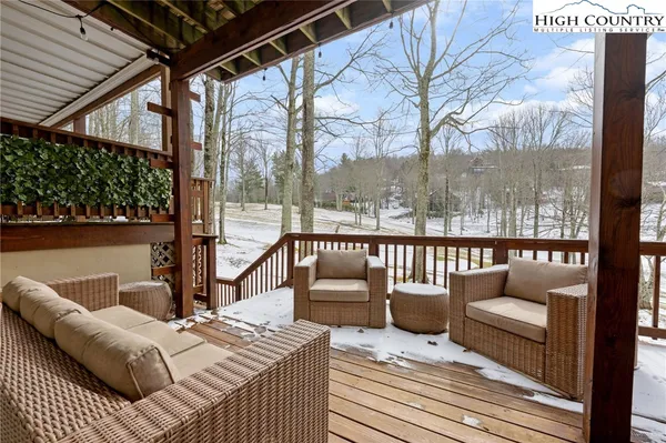 a balcony view with a couch and wooden floor