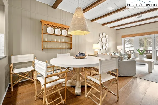 a view of a dining room with furniture and a chandelier