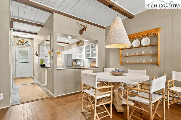 a view of a dining room with furniture and a chandelier