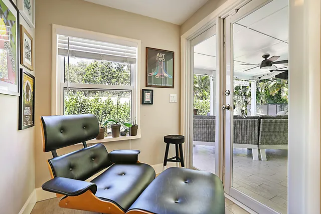 a living room with furniture and a floor to ceiling window