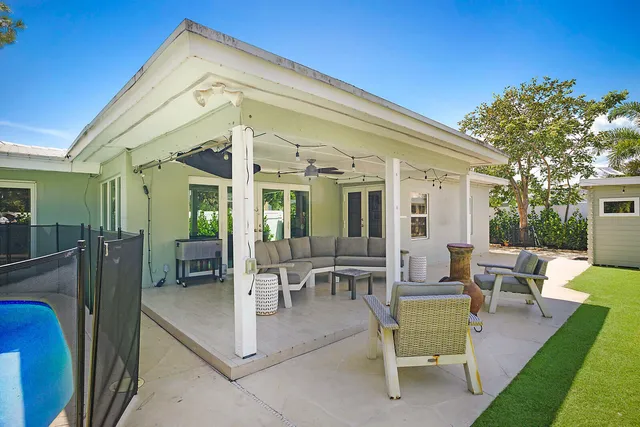 a view of a patio with couches table and chairs and potted plants
