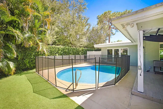 swimming pool view with a backyard space