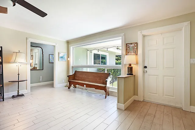 a bedroom with wooden floor and a window