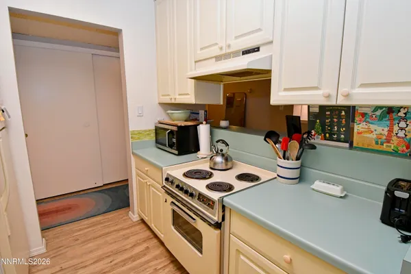 a kitchen with appliances cabinets and a counter top space