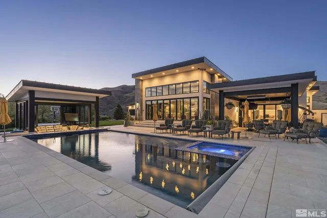 a view of a house with swimming pool and sitting area