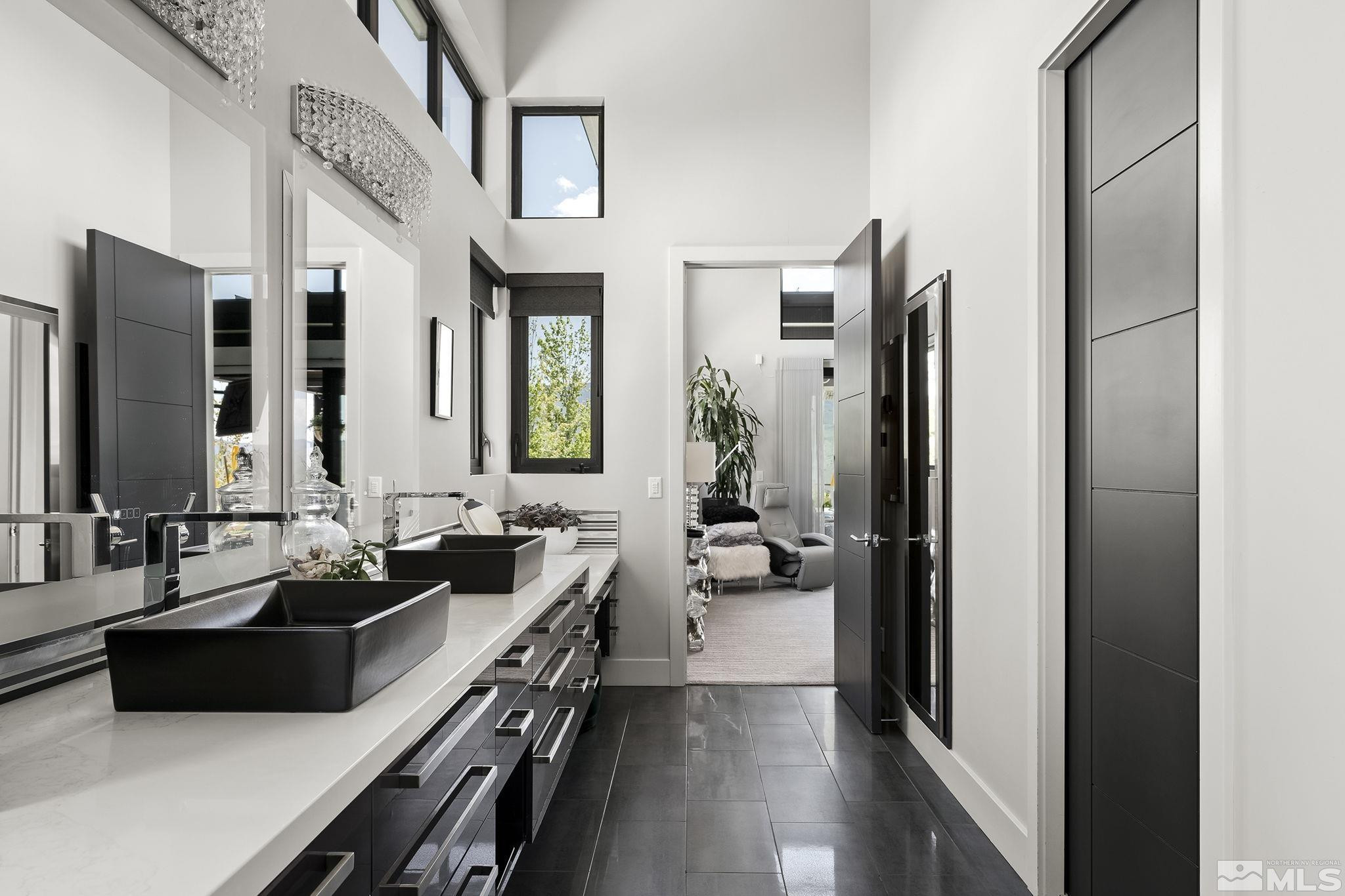 2385 Eagle Bend Trail Reno, NV 89523 - Photo 22 of 40 a bathroom with a double vanity sink a mirror and a bathtub
