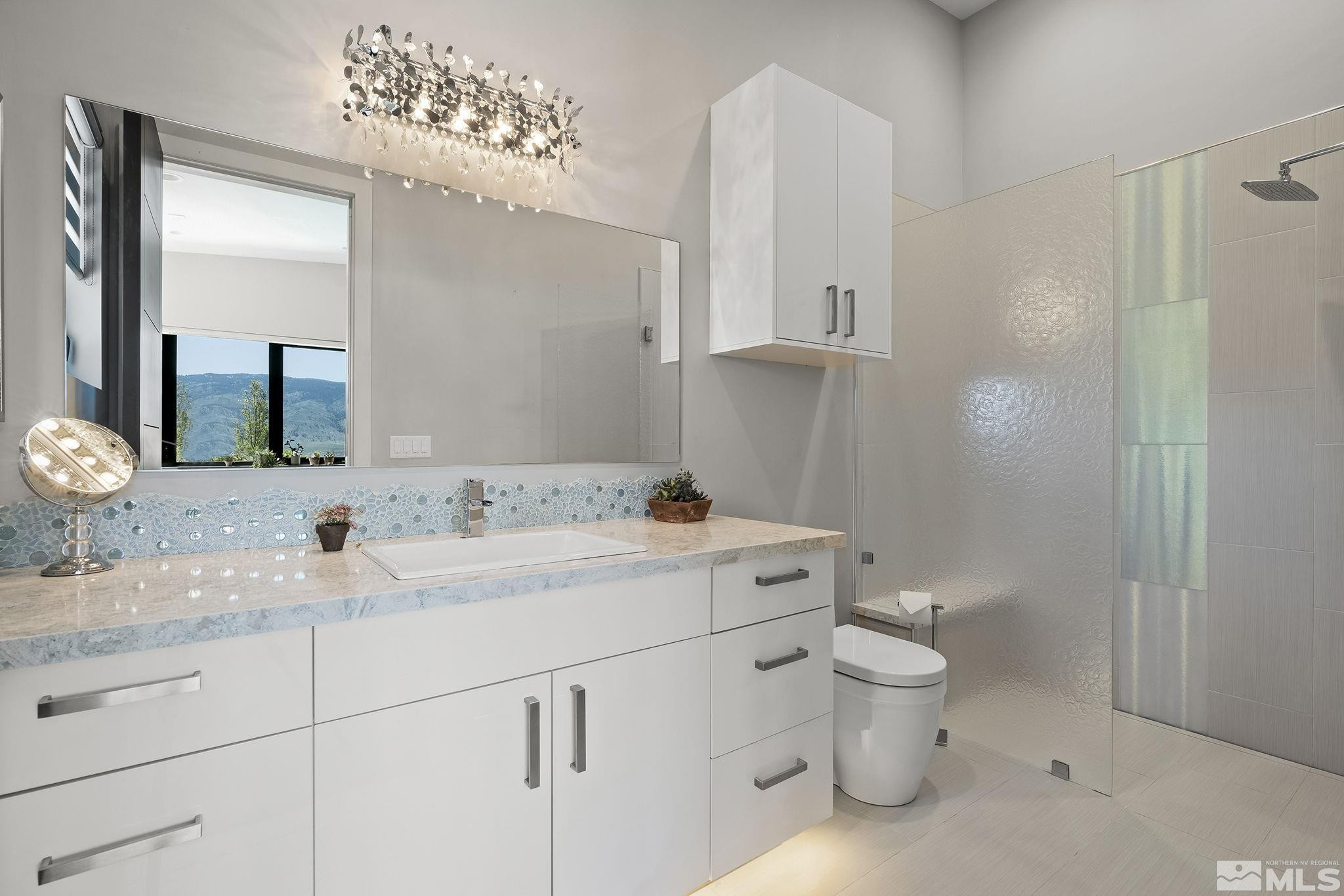 2385 Eagle Bend Trail Reno, NV 89523 - Photo 24 of 40 a bathroom with a toilet a sink and mirror