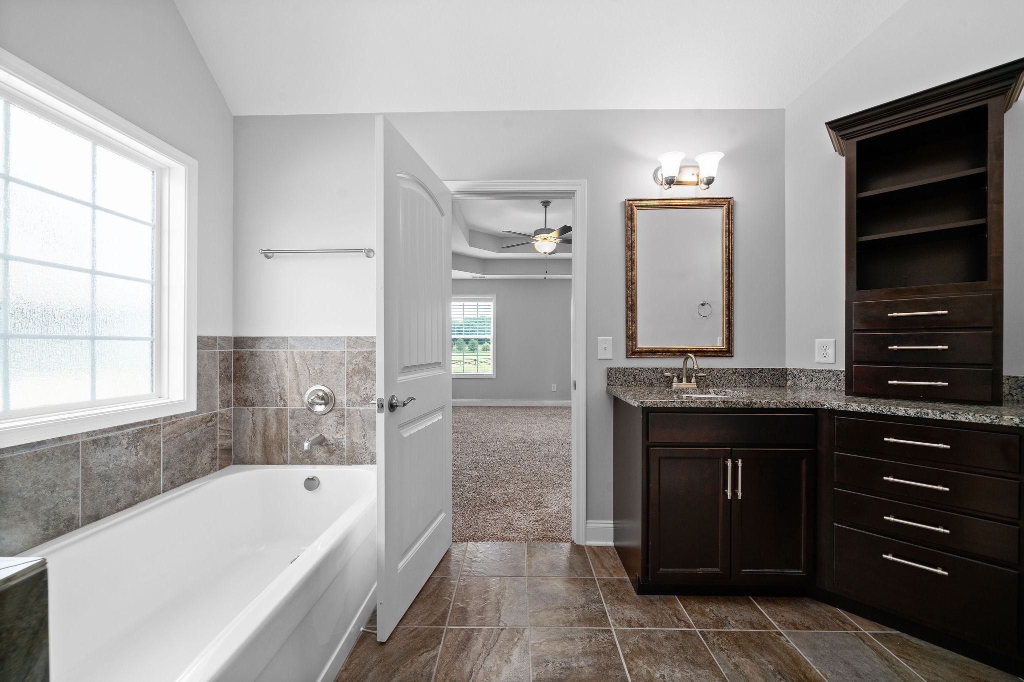 1008 Barnhill Road Clarksville, TN 37043 - Photo 31 of 44 a bathroom with a granite countertop bathtub a sink and a window